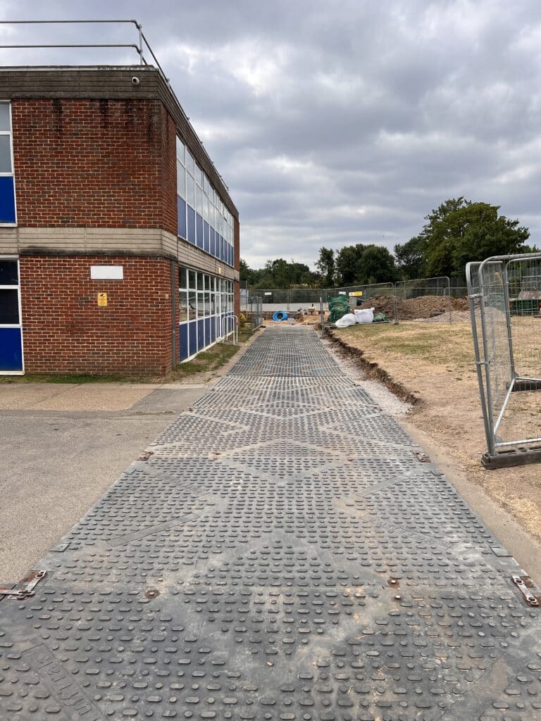 Temporary construction access road with ground protection mats at The Embrook School