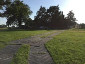 Temporary event access route installed across the grass at Hall Grove School using ground protection mats